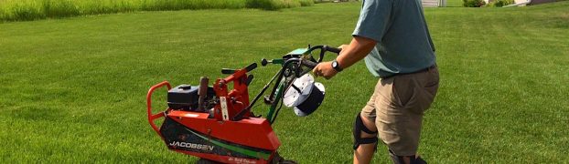 DogWatch Dealer using trencher to bury wire in ground